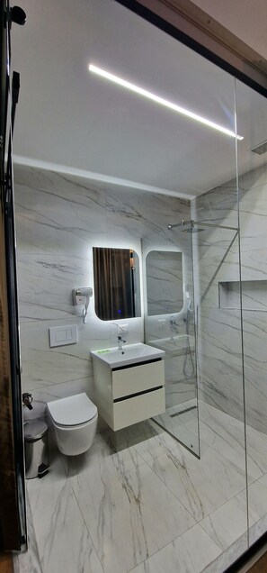 Deluxe Studio | Bathroom | Shower, hair dryer, slippers, towels - Arkle Apartment 6 (Tirana)