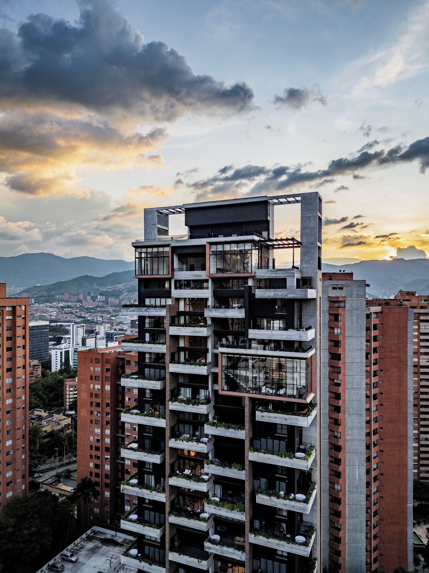 A high-rise building with multiple balconies, large windows, and a modern architectural design.