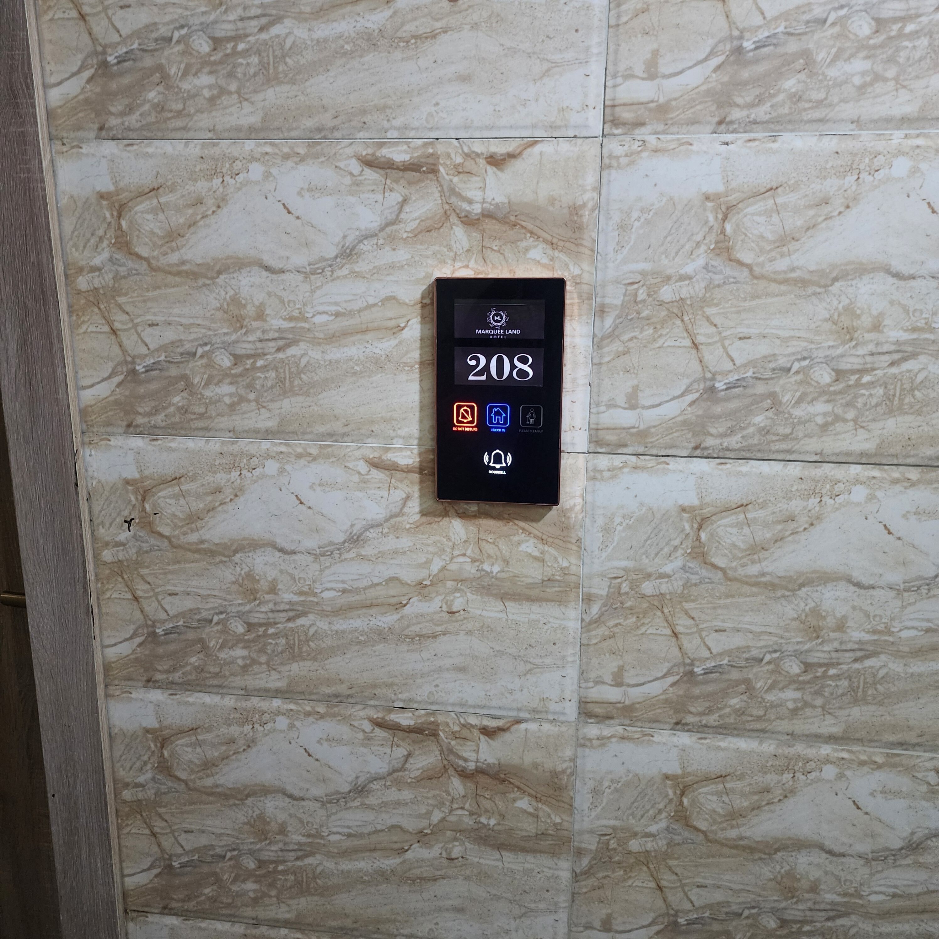 A digital key card reader with the number 208 displayed, indicating room number or access code.