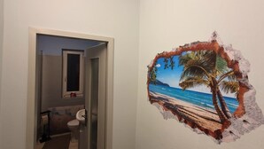A bathroom with a toilet, a towel rack, and a mirror. - Cozy vacation apartment Berlin for 9 people (Berlin)