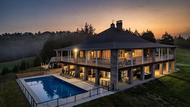 A large house with a pool, multiple balconies, and a spacious deck area. - Lakefront - Private Resort with INGROUND POOL! (Dandridge)
