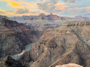 A canyon landscape with layered rock formations and a river. - The Shack #4                . (Williams)