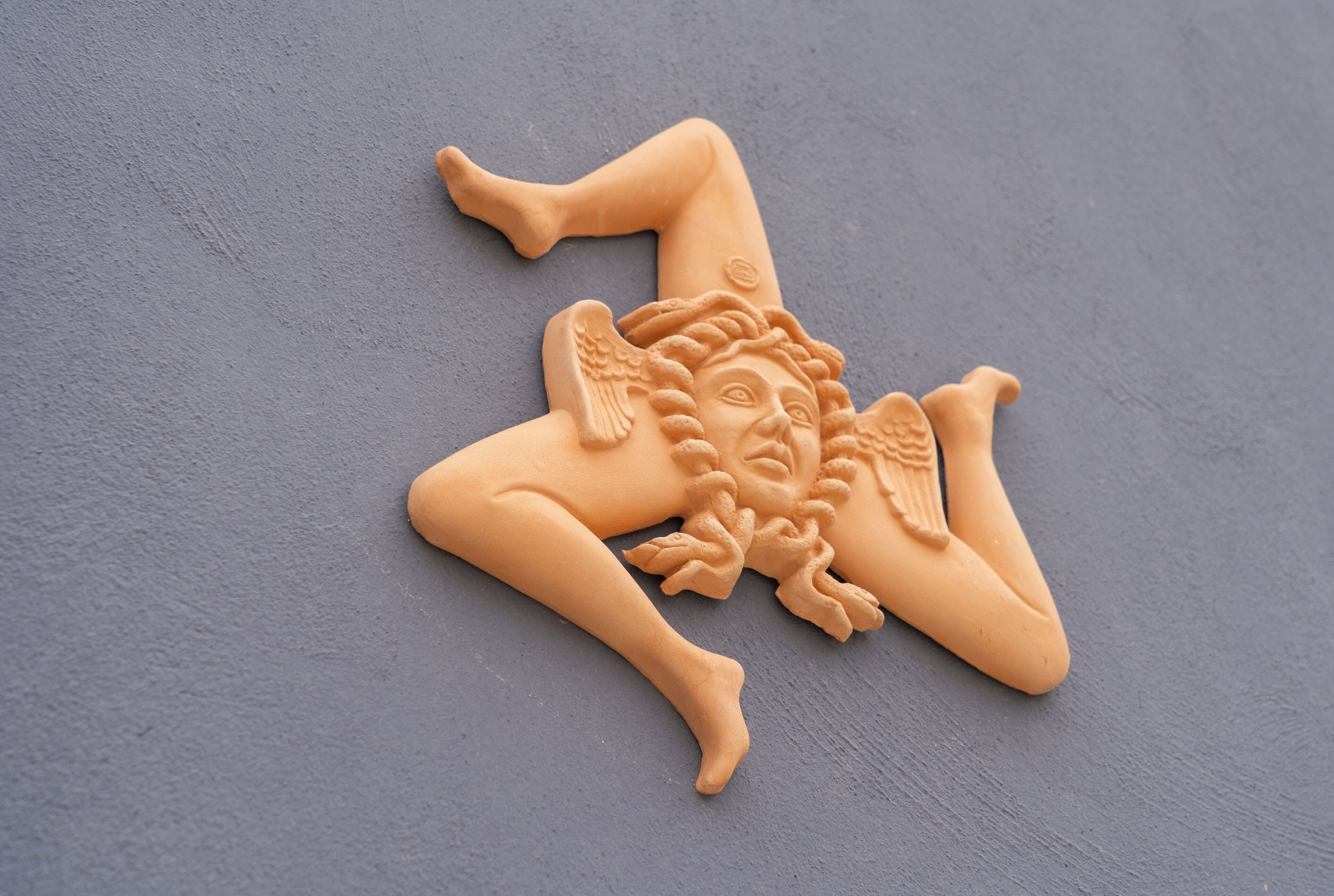 A star-shaped object with intricate designs on a textured surface.