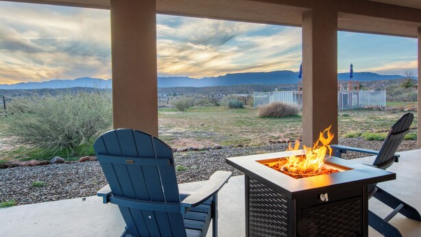 A patio with Adirondack chairs, a fire pit, and a view of mountains. - Romantic Wine Country Retreat • Private Hot Tub & Valley Views (Cornville)