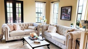 A living room with two sofas, a coffee table, and a framed picture on the wall. - 3Bedroom 2.5 bath townhome in beautiful Naples Florida

: (Naples)