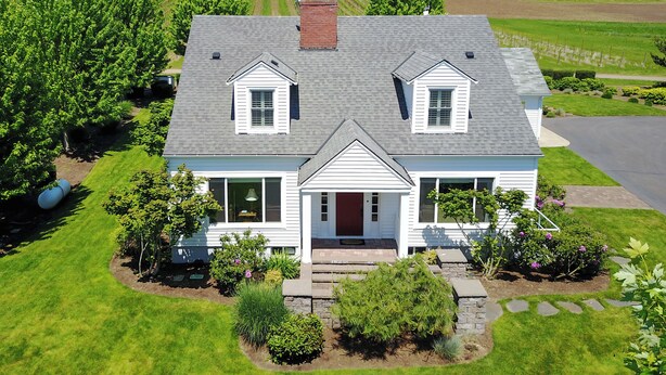 A two-story house with a gabled roof, a front porch, and a driveway leading to a garage. - Historic Vineyard Escape, with patio and vintage charm-Pet friendly! (Dayton)