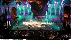 An ancient amphitheater with a stage and audience seating.