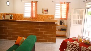 A compact living space with a kitchenette, a dining area, and a sofa. - BALISIER (2 to 4 people) (DESHAIES)