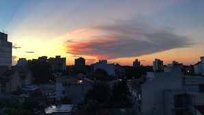 A cityscape at sunset with buildings silhouetted against a colorful sky. - MORON GREAT SUNSET (Morón)