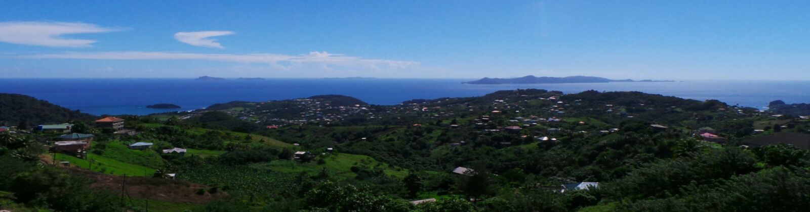 Eine Küstenlandschaft mit vereinzelten Häusern und Blick auf das Meer.