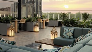 A rooftop terrace with seating, plants, and decorative lanterns. - Doubletree By Hilton Tashkent (Tashkent)