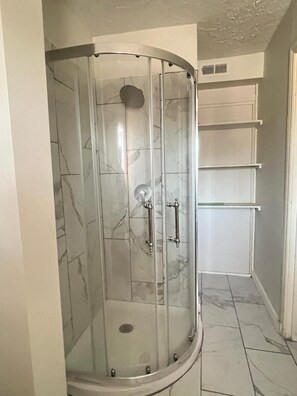 Shower, towels, soap, toilet paper