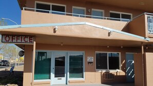 A two-story building with a sign reading "OFFICE" above the entrance. - Leisure Lodge Motel (Grants)
