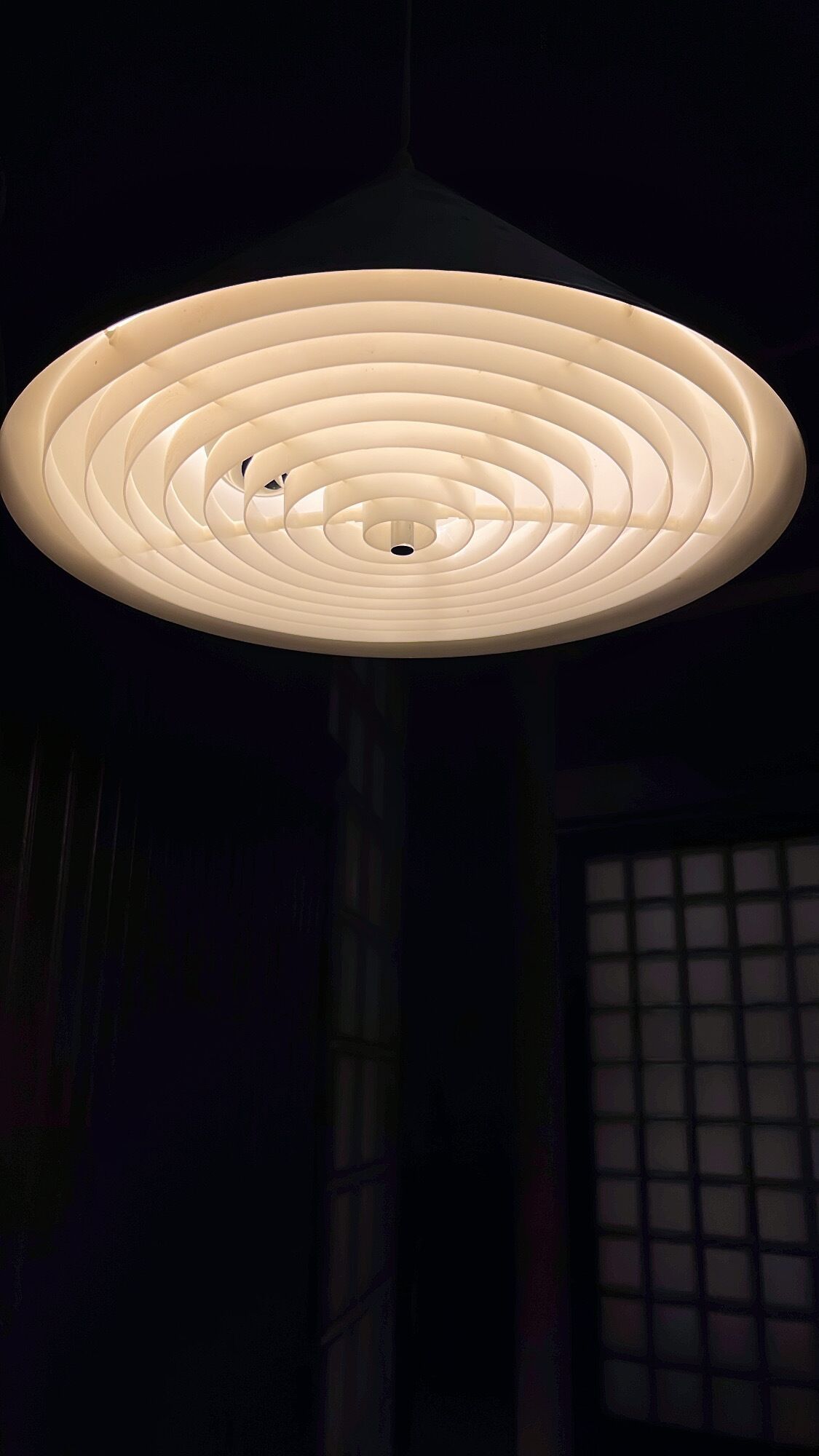A circular ceiling light fixture with concentric rings.
