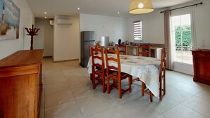 A spacious kitchen with a dining area, featuring a table with chairs, a hanging light fixture, and a view to the outside. - Regarding a WITHDRAWN LISTING: BEAUTIFUL 3-STAR-RATED HOUSE IN LA COTINIERE (Saint-Pierre D Oleron)
