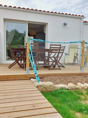 A wooden deck with a rope swing, a hammock, and outdoor furniture. - Regarding a WITHDRAWN LISTING: BEAUTIFUL 3-STAR-RATED HOUSE IN LA COTINIERE (Saint-Pierre D Oleron)