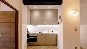 A modern kitchen with wooden cabinets, a countertop, and a built-in oven. - ✨ L'Instant Nîmois - Natural elegance in the heart of Nîmes ✨ (Nîmes)