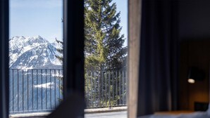 A room with a view of snow-covered mountains and a tree through a window. - Holiday Home in La Rosiere Near Ski Slopes (Montvalezan)