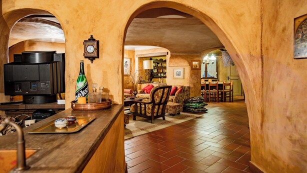 A cozy interior with a bar area, a television, and a clock on the wall. - Villa La Fortezza - Six Bedroom Villa, Sleeps 12 (Dormelletto)