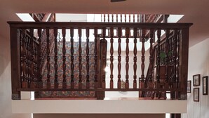 A living room with a sofa, patterned cushions, and a wooden staircase. - Rustic Casona w. Seaview, Fire Pit & AC between Cabo Rojo & Lajas (Cabo Rojo)