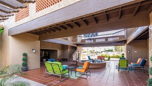 An outdoor patio with multiple seating areas, a fire pit, and a view of a pool and outdoor area. - Updated 1-bedroom queen/ Free WiFi, AC Resort of Greenfield Village Mesa 55+ (Mesa)