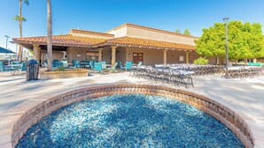 A building with a patio area featuring outdoor seating and a decorative pool. - Updated 1-bedroom queen/ Free WiFi, AC Resort of Greenfield Village Mesa 55+ (Mesa)