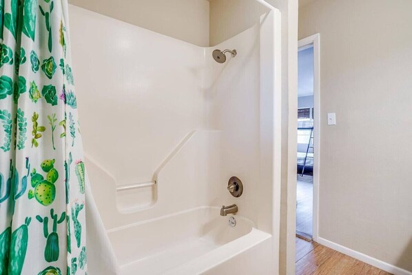 A bathroom with a shower, a toilet, and a sink.