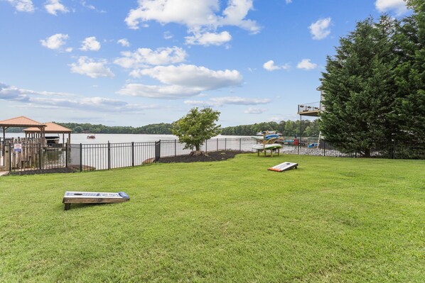 A grassy area with a small pool, a gazebo, and a fenced deck area. - Private Waterfront Home with Pool, Hot Tub - ideal for up to 16 (Denver)