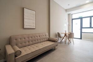A modern waiting area with a sofa, chairs, and a table. - VLC HOST - Sumsi B (Valencia)
