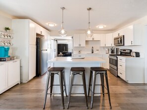 Fridge, microwave, coffee/tea maker, cookware/dishes/utensils