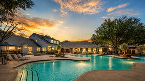 A swimming pool with lounge chairs, a deck area, and a building with multiple windows and a covered patio. - Austin 3BR Home for Families & Groups · Sleeps 10 · 10min to UT (Austin)