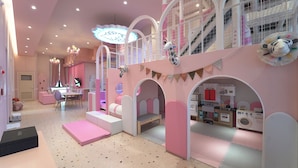 A children's play area with pink and white decor, including a play kitchen and a slide. - BUSAN ALMOND KIDS POOL VILLA NAMPO (Busan)