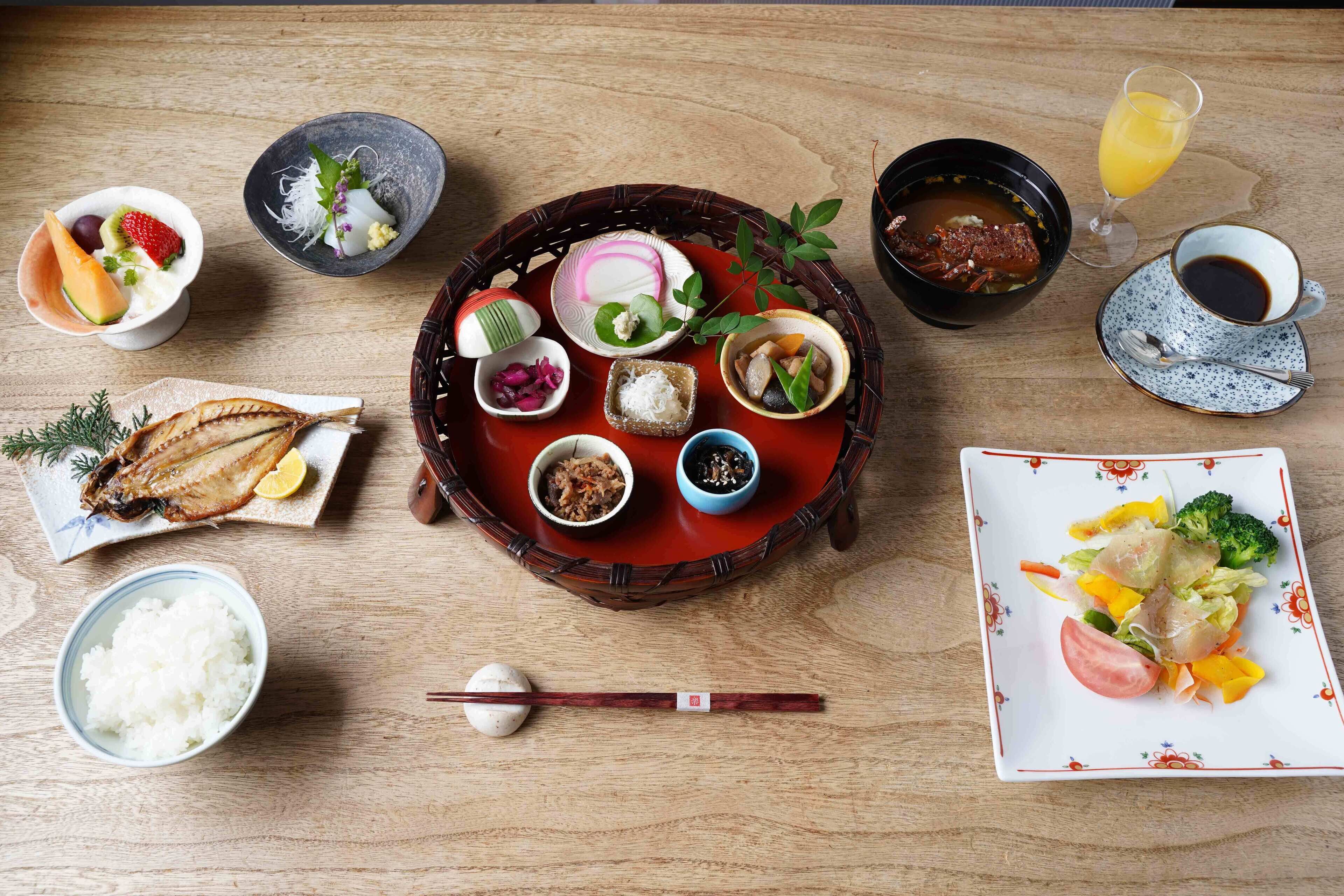 A wooden table with various dishes, including rice, soup, and vegetables.