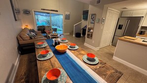A modern kitchen with a wooden countertop and a built-in refrigerator.