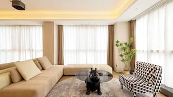 Luxury Apartment, City View | Living area | 120-inch Smart TV with cable channels