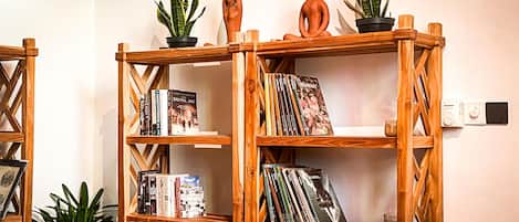 A wooden bookshelf with books and decorative items.