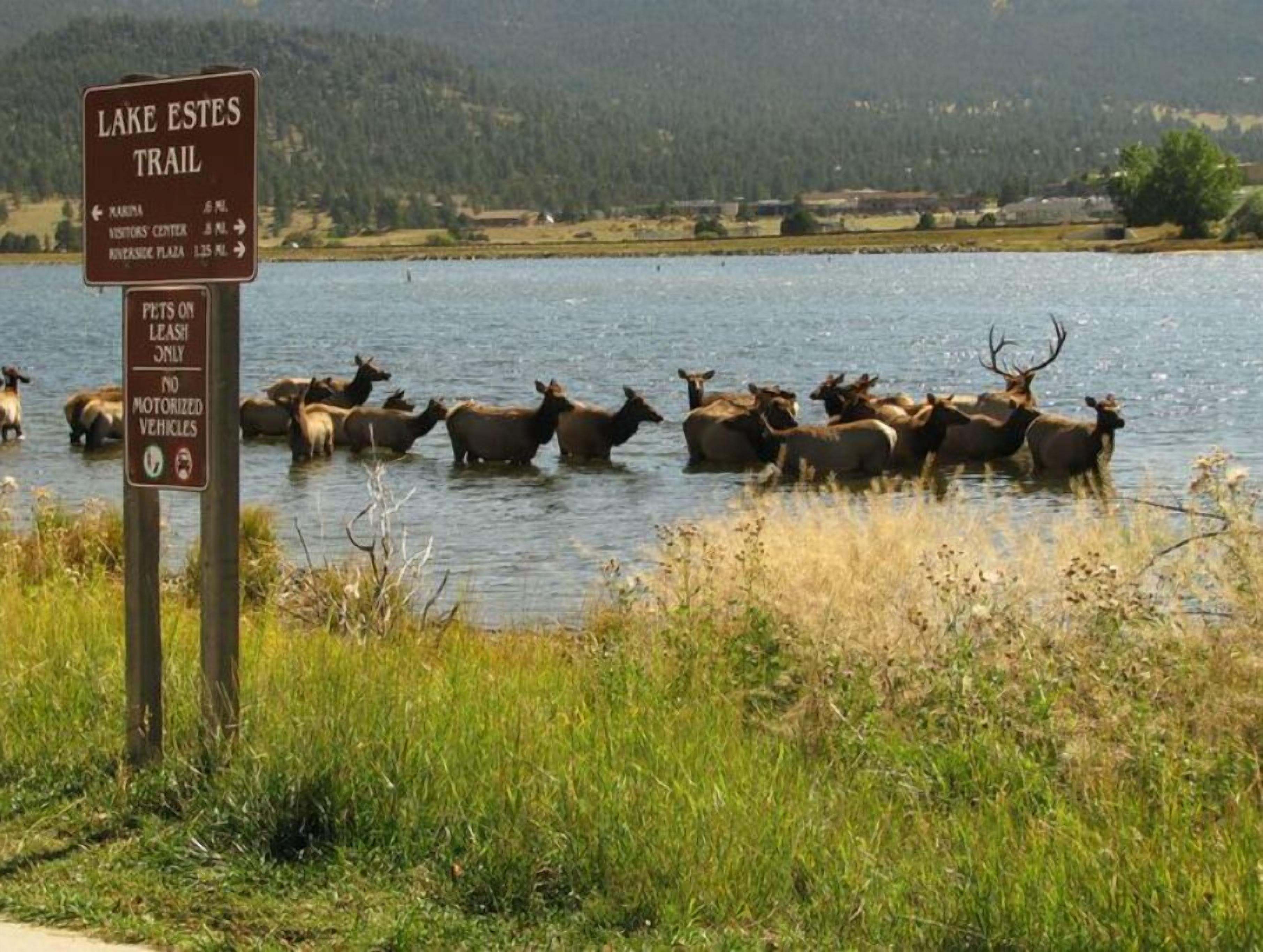 A sign for the Lake Estes Trail with directions to various points of interest.