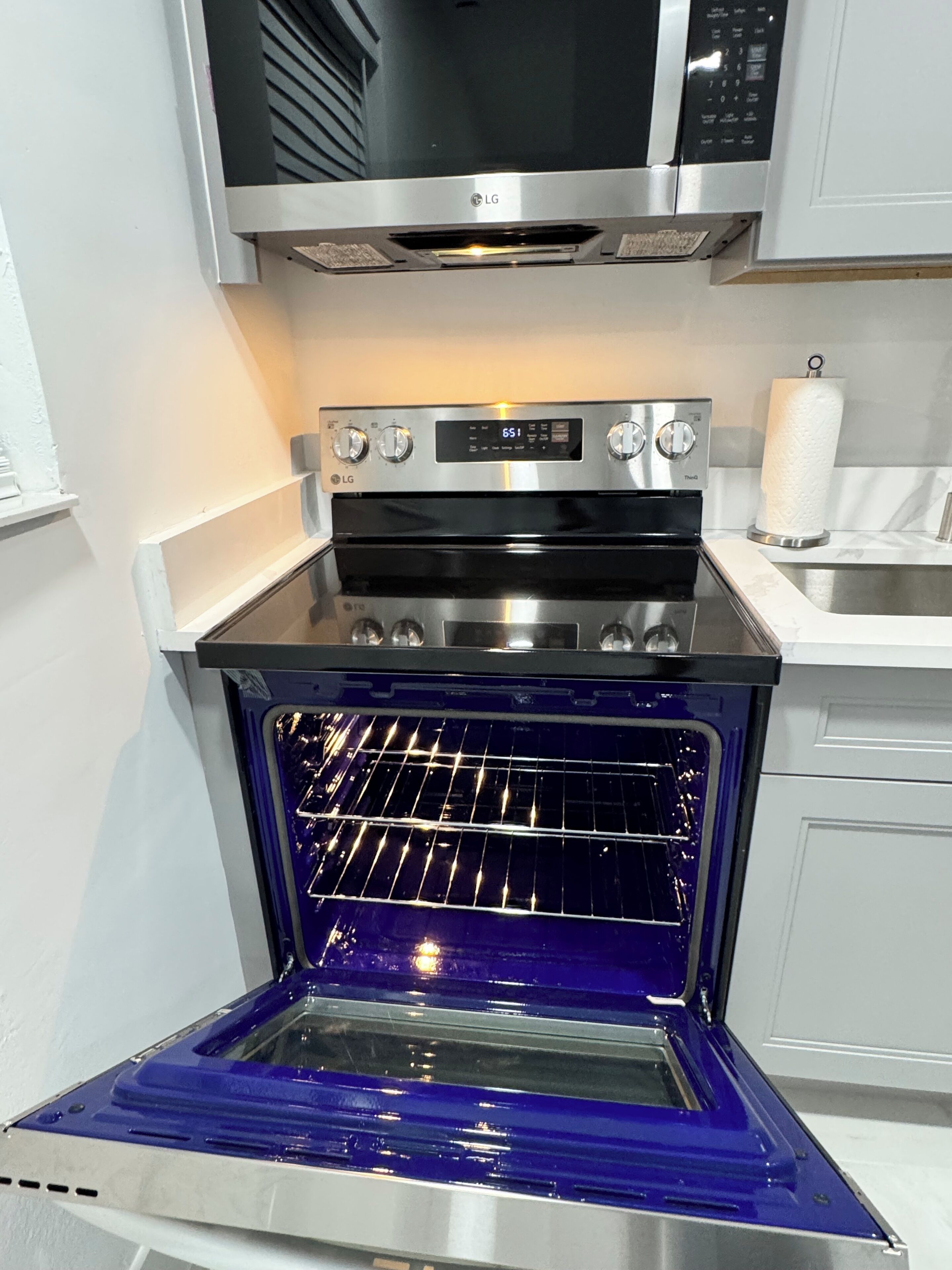 A kitchen with a built-in oven and microwave.