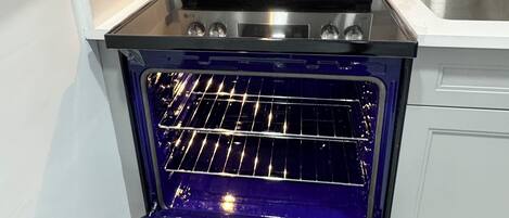 A kitchen with a built-in oven and microwave.