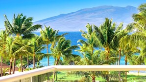 A tropical resort with palm trees, a view of the ocean, and a mountain in the background. - Honua Kai Konea Collection by KBM - 3 Units on same floor (524/537/539) (Kaanapali)
