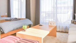 A hotel room with a bed, a desk, a chair, and a sofa. - Triphome Nakano 2025 New 6min JR 4min Shinjuku (Nakano City)