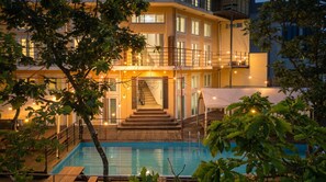 A two-story building with a pool, surrounded by trees and string lights. - Gapyeong Nami Island Pool & Spa Pension (Gapyeong)