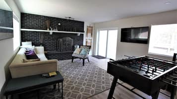 Signature Cabin, 3 Bedrooms, Patio | Living room | 40-inch Smart TV with digital channels, fireplace, foosball