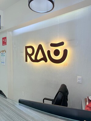 A reception area with a wall-mounted sign displaying the name 'RAO'.