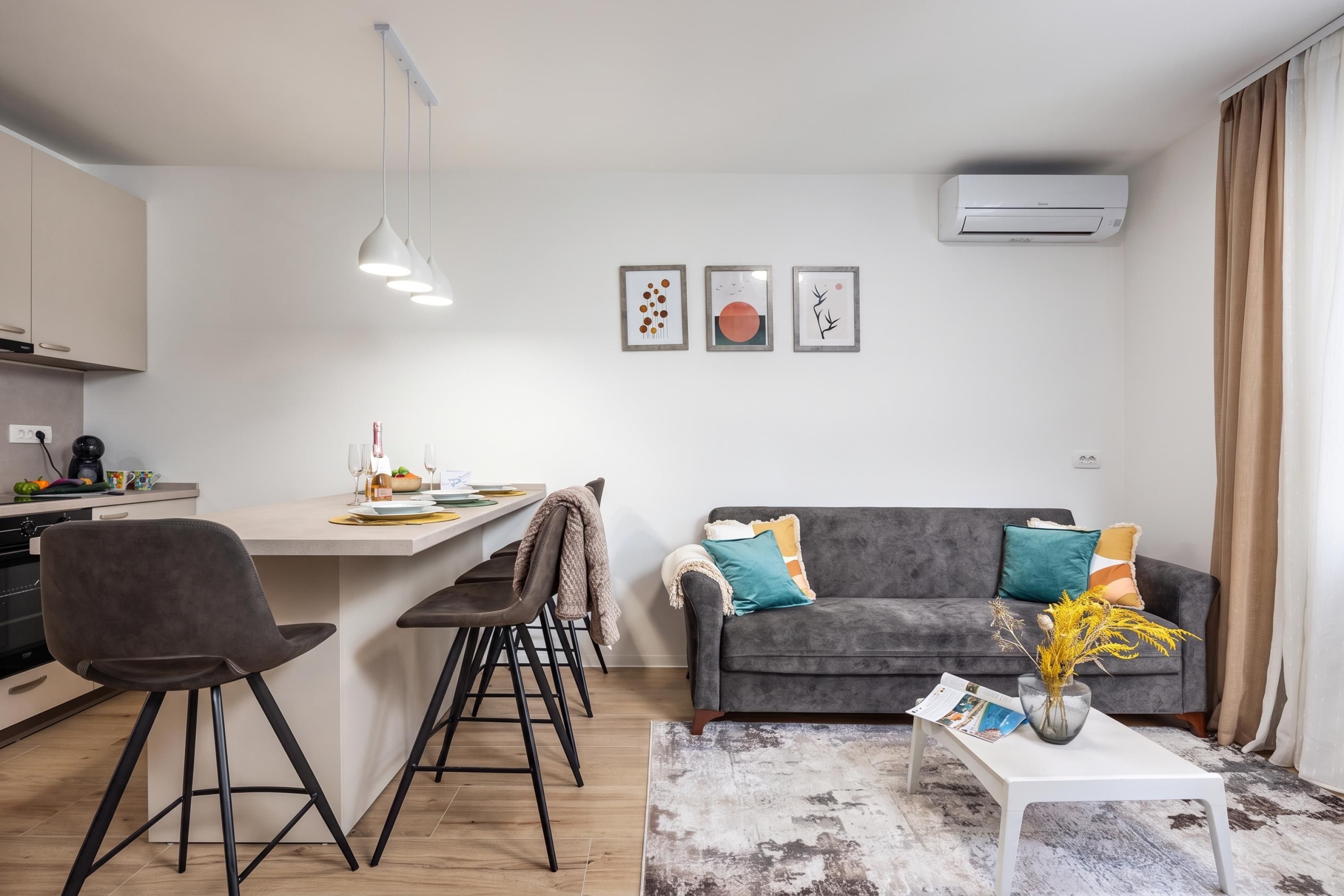A modern living space with a kitchen, dining area, and seating area.