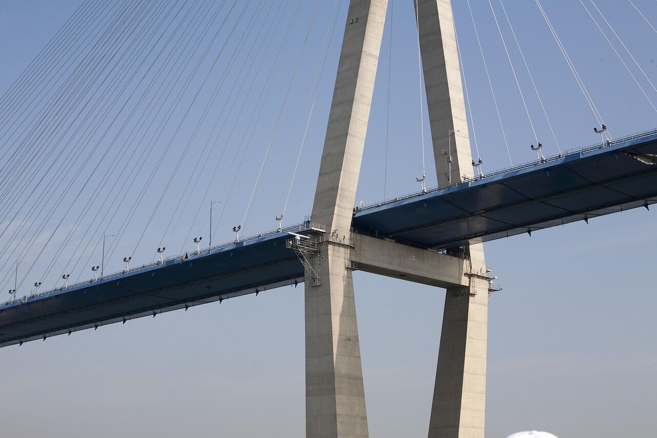 A large suspension bridge with two main towers and cables.
