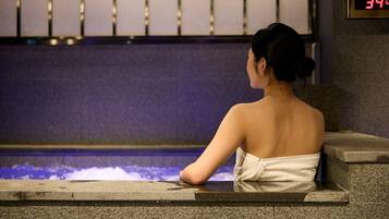 A person sitting by a pool with a digital clock displaying 3:40.
