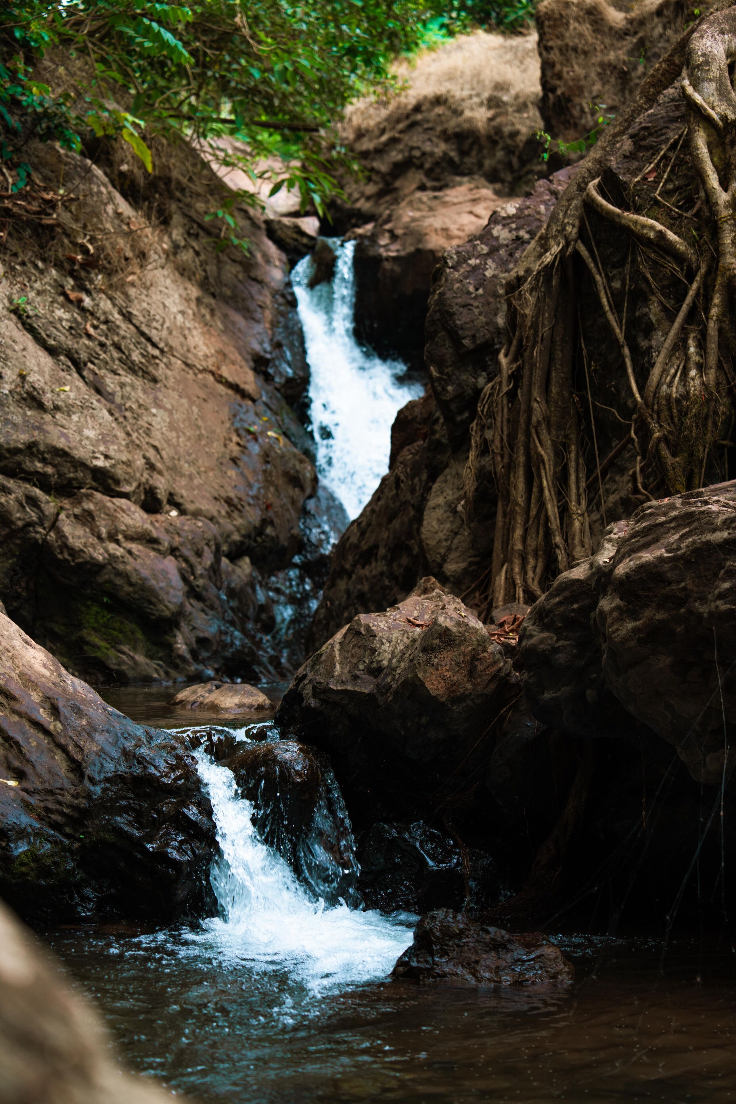 A waterfall cascading over rocks in a natural setting.