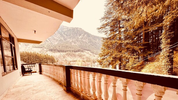 A balcony with a view of a mountainous landscape.