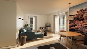 Ein modernes Wohnzimmer mit einer Couch, einem Esstisch mit Stühlen, einem Fernseher und einem großen Fenster mit Blick auf einen Wald.